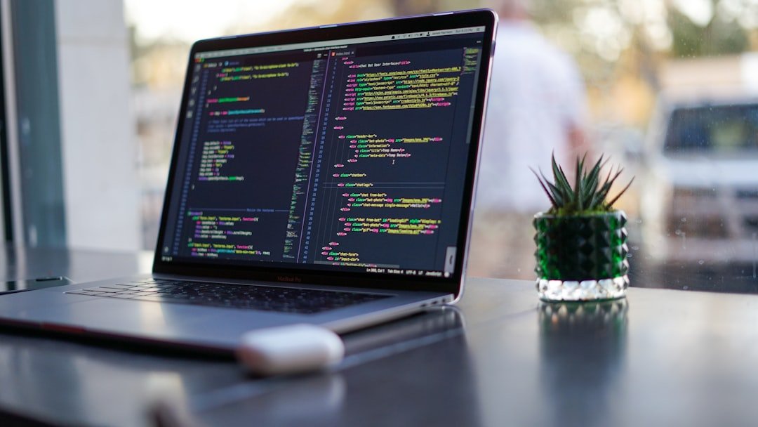 About Laptop with code and plant in coffee shop